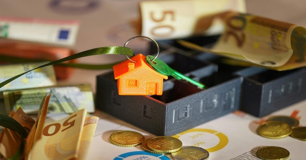 house and coins on a desk